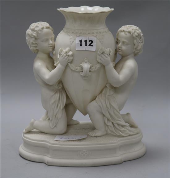 A centrepiece of putti holding a vase